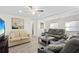 Relaxing living room with gray sofas, wood-look floors, and a TV at 5298 Palena Blvd, North Port, FL 34287