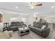 Spacious living room with comfortable gray reclining sofas and wood-look flooring at 5298 Palena Blvd, North Port, FL 34287