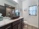 Modern bathroom with dark brown vanity, vessel sink, and a walk-in shower at 5870 Hornbuckle Blvd, North Port, FL 34291