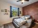 bedroom with dinosaur bedding and a brick feature wall at 5870 Hornbuckle Blvd, North Port, FL 34291