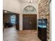 Bright entryway with double doors, stone wall, and fish tank at 5870 Hornbuckle Blvd, North Port, FL 34291