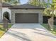 Attached two-car garage with paver driveway and wrought iron gates at 5870 Hornbuckle Blvd, North Port, FL 34291