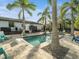 Relaxing pool area with lounge chairs, palm trees, and a basketball hoop at 5870 Hornbuckle Blvd, North Port, FL 34291