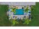 Aerial view of refreshing blue pool, surrounded by palm trees and lounge chairs at 5870 Hornbuckle Blvd, North Port, FL 34291