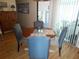 Small round dining table with blue upholstered chairs at 6815 Amoko Ct, North Port, FL 34287