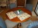 Round dining table with four chairs in a casual setting at 6815 Amoko Ct, North Port, FL 34287