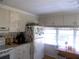 Bright kitchen features white cabinets and a breakfast table at 6815 Amoko Ct, North Port, FL 34287