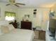 Comfortable main bedroom with a king-size bed and built-in shelving at 6815 Amoko Ct, North Port, FL 34287