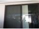 Sliding glass door with vertical blinds at 6815 Amoko Ct, North Port, FL 34287