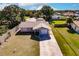 Aerial view of a single-story house with a large backyard and driveway at 701 Coral Way, Englewood, FL 34223