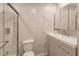 Modern bathroom with marble tile and a walk-in shower at 701 Coral Way, Englewood, FL 34223