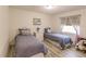 Two twin beds in a bright bedroom with light flooring at 701 Coral Way, Englewood, FL 34223