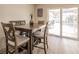 Dining area with table and chairs, view of pool through sliding doors at 701 Coral Way, Englewood, FL 34223