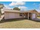 Single story house with light colored siding, attached garage and landscaped lawn at 701 Coral Way, Englewood, FL 34223