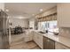 Modern kitchen with white cabinets, stainless steel appliances, and quartz countertops at 701 Coral Way, Englewood, FL 34223