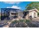 Screened pool area with patio furniture and grill at 701 Coral Way, Englewood, FL 34223