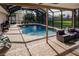 Spacious pool and patio area with screened enclosure at 701 Coral Way, Englewood, FL 34223