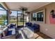 Relaxing screened porch with seating and ceiling fan at 701 Coral Way, Englewood, FL 34223