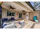 Outdoor patio with seating and screened enclosure at 701 Coral Way, Englewood, FL 34223
