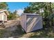 Tan storage shed in backyard of property at 701 Coral Way, Englewood, FL 34223