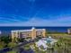 Building and community pool with water view at 101 N. Marion Court # 222, Punta Gorda, FL 33950