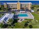 Aerial view of waterfront community with pool, building, and parking at 101 N. Marion Court # 222, Punta Gorda, FL 33950