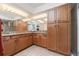 Bathroom with double vanity, granite countertop, and wood cabinets at 101 N. Marion Court # 222, Punta Gorda, FL 33950
