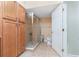 Bathroom with shower, toilet and wood cabinets at 101 N. Marion Court # 222, Punta Gorda, FL 33950