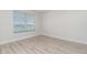 Bedroom with wood-look flooring and window blinds at 101 N. Marion Court # 222, Punta Gorda, FL 33950