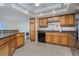 Spacious kitchen with wood cabinets, granite counters, and stainless steel appliances at 101 N. Marion Court # 222, Punta Gorda, FL 33950
