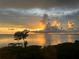 Dramatic sunset over calm water and pier at 101 N. Marion Court # 222, Punta Gorda, FL 33950