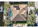 Overhead view of a canal-front home with solar panels and pool at 1131 Via Tripoli, Punta Gorda, FL 33950