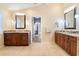 Double vanity bathroom with granite countertops and large mirrors at 1131 Via Tripoli, Punta Gorda, FL 33950
