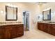 Double vanity bathroom with granite countertops and large mirrors at 1131 Via Tripoli, Punta Gorda, FL 33950
