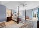 Spacious main bedroom with a post bed, hardwood floors and sliding doors to the pool at 1131 Via Tripoli, Punta Gorda, FL 33950