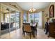 Bright dining room with pool view, table for six, and access to patio at 1131 Via Tripoli, Punta Gorda, FL 33950