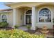 Front entrance with double doors, fountain, and landscaping at 1131 Via Tripoli, Punta Gorda, FL 33950