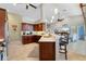 Modern kitchen with wood cabinetry, breakfast bar and stainless steel appliances at 1131 Via Tripoli, Punta Gorda, FL 33950