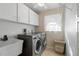Laundry room with washer, dryer, and storage cabinets at 1131 Via Tripoli, Punta Gorda, FL 33950