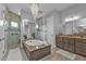 Elegant bathroom with a soaking tub, double vanity, and walk-in shower at 1220 Spanish Cay Ln, Punta Gorda, FL 33950