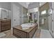 Elegant bathroom with a soaking tub, double vanity, and walk-in shower at 1220 Spanish Cay Ln, Punta Gorda, FL 33950
