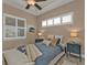 Well-lit bedroom featuring a comfortable bed and window shutters at 1220 Spanish Cay Ln, Punta Gorda, FL 33950