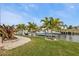 Beautiful canal-front yard with lush tropical plants at 1220 Spanish Cay Ln, Punta Gorda, FL 33950