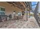 Covered patio features a dining area and outdoor kitchen at 1220 Spanish Cay Ln, Punta Gorda, FL 33950
