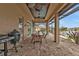 Covered patio with dining area, grill, and serene water views at 1220 Spanish Cay Ln, Punta Gorda, FL 33950