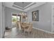 Elegant dining room with chandelier and access to backyard at 1220 Spanish Cay Ln, Punta Gorda, FL 33950