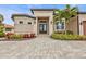 Elegant entryway with double doors and paver driveway at 1220 Spanish Cay Ln, Punta Gorda, FL 33950