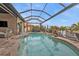 Stunning kidney-shaped pool with a screened enclosure at 1220 Spanish Cay Ln, Punta Gorda, FL 33950