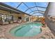 Relaxing kidney-shaped pool with screened enclosure at 1220 Spanish Cay Ln, Punta Gorda, FL 33950