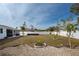 Backyard view showcasing a large lawn and hot tub at 1236 Fleetwood Nw Dr, Port Charlotte, FL 33948